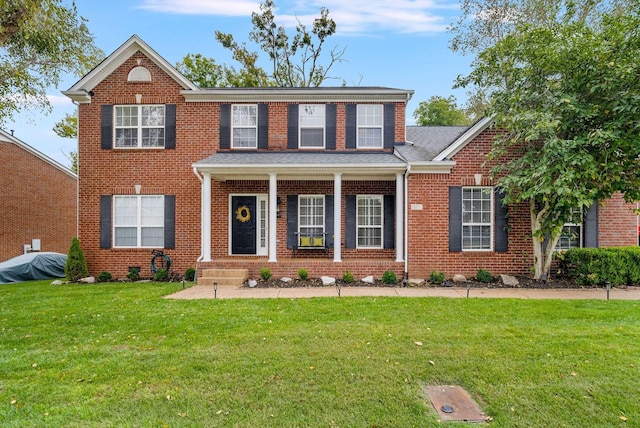 720 N Wickshire Way, Brentwood, TN 37027 - view of front of property with a front yard, brick siding, and a shingled roof