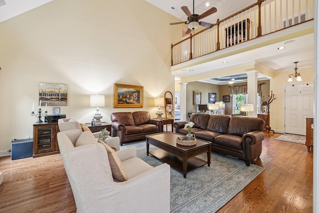 835 Banner Dr, Murfreesboro, TN 37129 - living area featuring ornate columns, a ceiling fan, wood finished floors, a towering ceiling, and ornamental molding