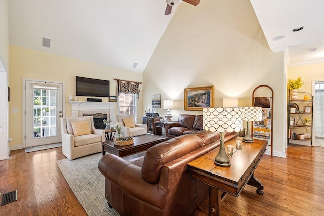 835 Banner Dr, Murfreesboro, TN 37129 - living room featuring a fireplace, high vaulted ceiling, wood finished floors, a ceiling fan, and crown molding