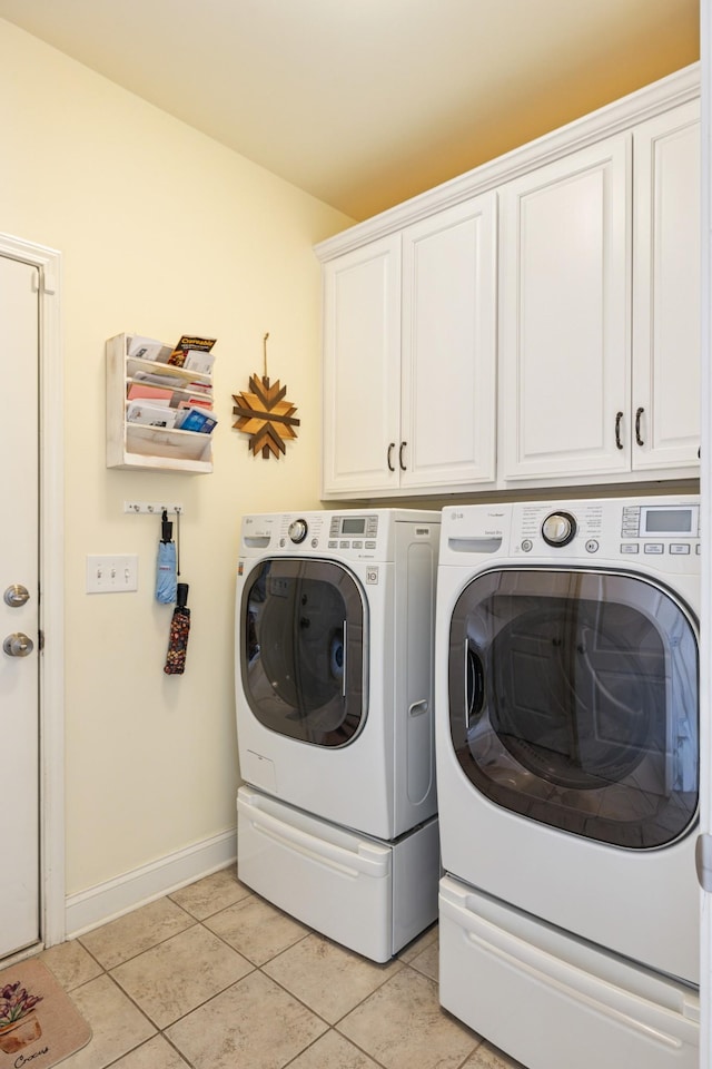 835 Banner Dr, Murfreesboro, TN 37129 - laundry area featuring cabinet space, washing machine and dryer, and light tile patterned floors