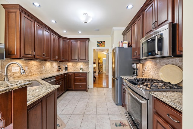 835 Banner Dr, Murfreesboro, TN 37129 - kitchen with appliances with stainless steel finishes, light stone counters, ornamental molding, light tile patterned flooring, and decorative backsplash