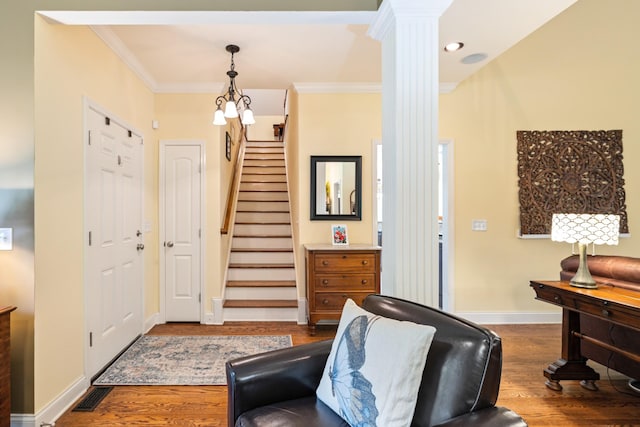 835 Banner Dr, Murfreesboro, TN 37129 - living area with decorative columns, crown molding, dark wood-style floors, and stairway