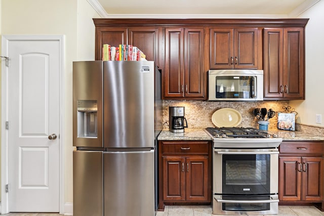 835 Banner Dr, Murfreesboro, TN 37129 - kitchen with stainless steel appliances, light stone countertops, decorative backsplash, and ornamental molding