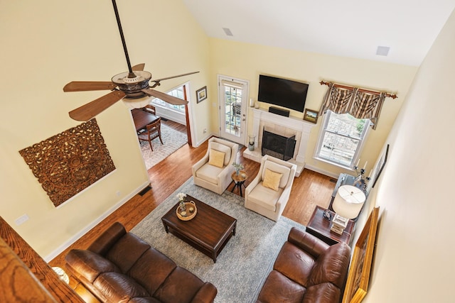 835 Banner Dr, Murfreesboro, TN 37129 - living room with a ceiling fan, wood finished floors, high vaulted ceiling, and a tiled fireplace