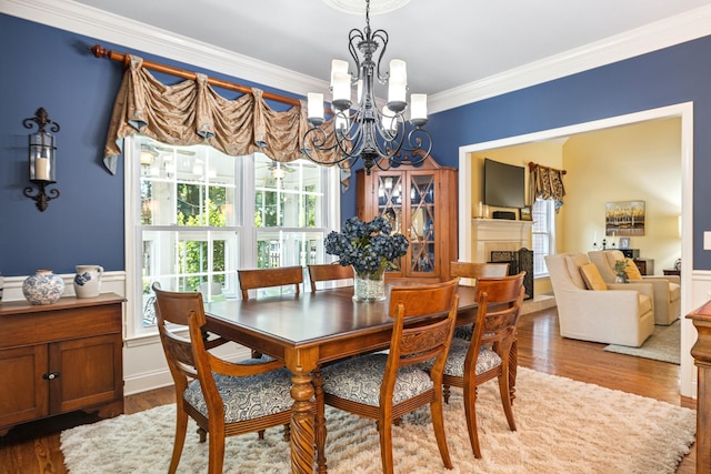 835 Banner Dr, Murfreesboro, TN 37129 - dining space featuring a chandelier, ornamental molding, healthy amount of natural light, and wood finished floors