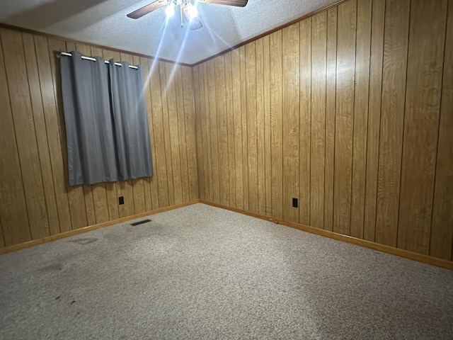638 Chitwood Dr, Lafayette, TN 37083 - empty room with ceiling fan, carpet flooring, a textured ceiling, and wooden walls