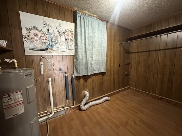 638 Chitwood Dr, Lafayette, TN 37083 - laundry room featuring water heater, wooden walls, wood finished floors, and a textured ceiling