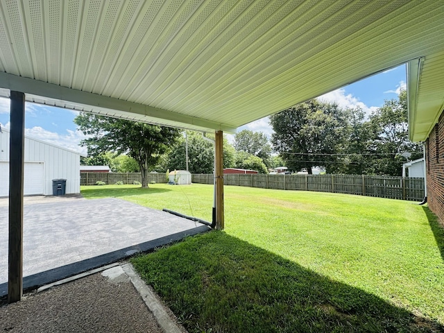 638 Chitwood Dr, Lafayette, TN 37083 - fenced backyard featuring an outdoor structure and a patio area