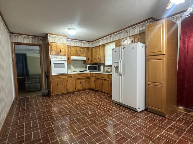 638 Chitwood Dr, Lafayette, TN 37083 - kitchen featuring brick floors, white appliances, a textured ceiling, light countertops, and brown cabinets