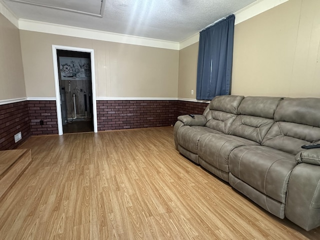 638 Chitwood Dr, Lafayette, TN 37083 - living room with light wood-style flooring, brick wall, wainscoting, and crown molding
