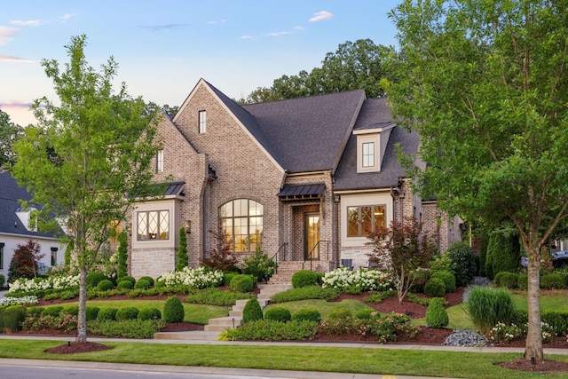 8524 Heirloom Blvd, College Grove, TN 37046 - french country style house featuring brick siding, roof with shingles, and stone siding