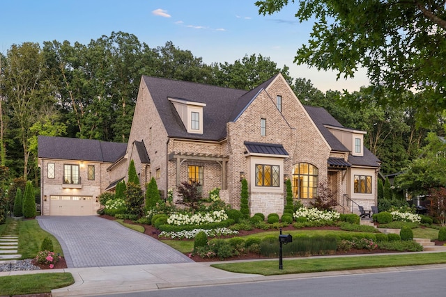 8524 Heirloom Blvd, College Grove, TN 37046 - french country style house with decorative driveway, an attached garage, brick siding, stone siding, and roof with shingles