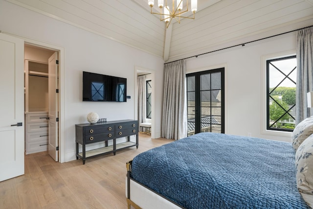 8524 Heirloom Blvd, College Grove, TN 37046 - bedroom with a chandelier, light wood-type flooring, and a spacious closet