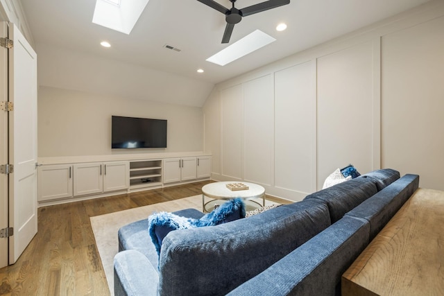 8524 Heirloom Blvd, College Grove, TN 37046 - living room with a skylight, a decorative wall, lofted ceiling, wood finished floors, and recessed lighting