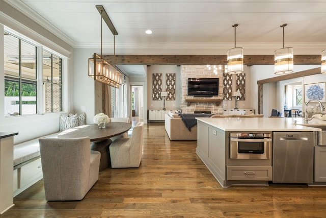 8524 Heirloom Blvd, College Grove, TN 37046 - kitchen featuring gray cabinets, open floor plan, stainless steel appliances, crown molding, and dark wood finished floors