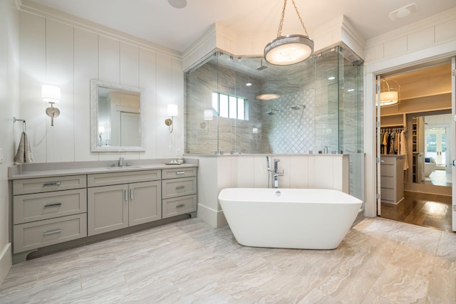 8524 Heirloom Blvd, College Grove, TN 37046 - bathroom featuring a stall shower, vanity, a freestanding tub, a spacious closet, and a decorative wall