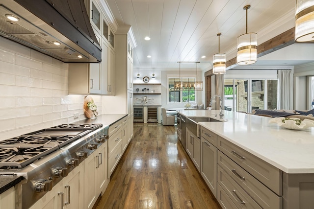 8524 Heirloom Blvd, College Grove, TN 37046 - kitchen with stainless steel gas stovetop, ventilation hood, open floor plan, dark wood finished floors, and decorative light fixtures