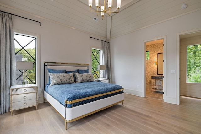 8524 Heirloom Blvd, College Grove, TN 37046 - bedroom featuring wood finished floors, a chandelier, and ensuite bath