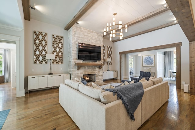 8524 Heirloom Blvd, College Grove, TN 37046 - living area featuring a stone fireplace, beam ceiling, wood finished floors, and a chandelier