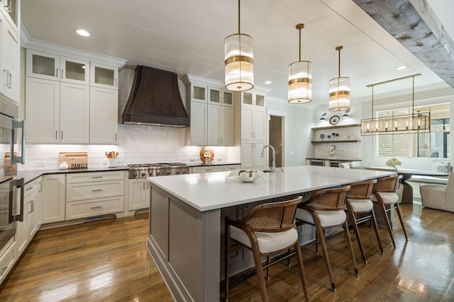 8524 Heirloom Blvd, College Grove, TN 37046 - kitchen with premium range hood, tasteful backsplash, dark wood-type flooring, a kitchen bar, and recessed lighting