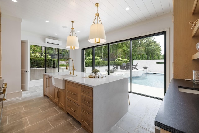 8524 Heirloom Blvd, College Grove, TN 37046 - kitchen with recessed lighting, a center island with sink, pendant lighting, range, and brown cabinetry
