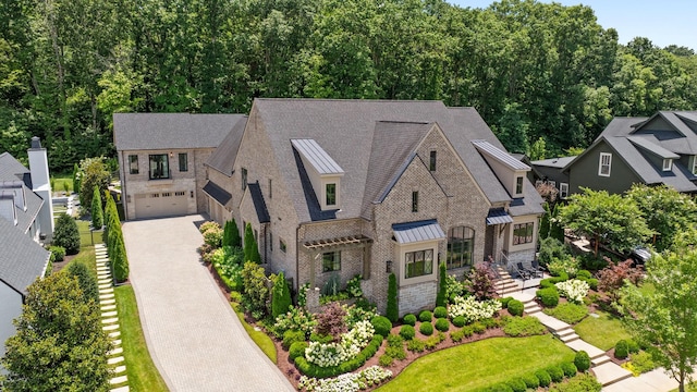8524 Heirloom Blvd, College Grove, TN 37046 - view of front of property with driveway, a standing seam roof, a shingled roof, and brick siding