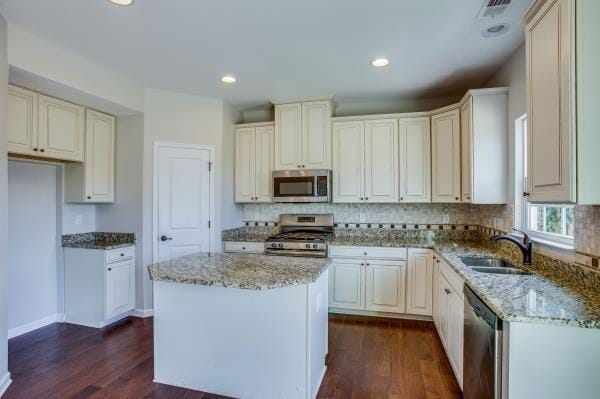 107 Clavie Crew Ln, Spring Hill, TN 37174 - kitchen featuring light stone counters, dark wood-style flooring, stainless steel appliances, tasteful backsplash, and recessed lighting