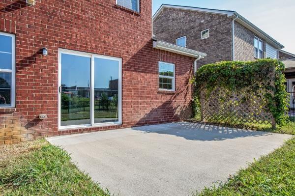 107 Clavie Crew Ln, Spring Hill, TN 37174 - view of side of property featuring a patio area and brick siding