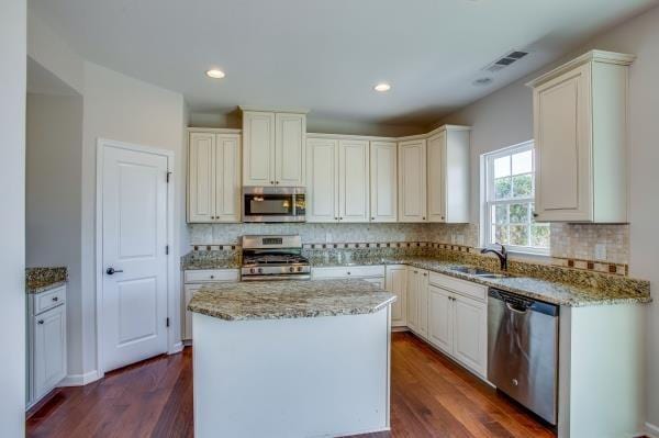 107 Clavie Crew Ln, Spring Hill, TN 37174 - kitchen featuring appliances with stainless steel finishes, light stone counters, backsplash, and recessed lighting