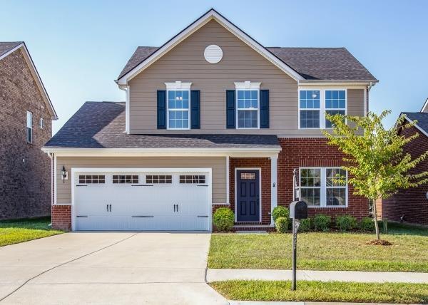 107 Clavie Crew Ln, Spring Hill, TN 37174 - view of front of home featuring concrete driveway, a front lawn, brick siding, and a shingled roof