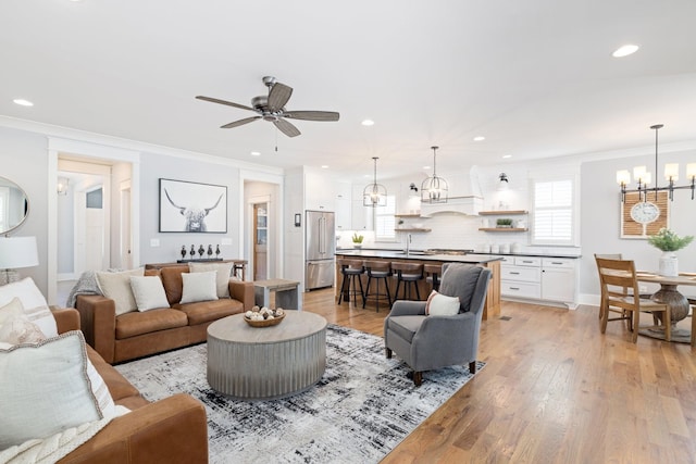 212 Rich Cir, Franklin, TN 37064 - living room featuring a chandelier, a ceiling fan, healthy amount of natural light, recessed lighting, and light wood-style floors