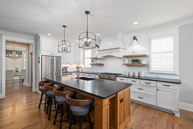 212 Rich Cir, Franklin, TN 37064 - kitchen featuring a chandelier, dark countertops, open shelves, backsplash, and a center island with sink