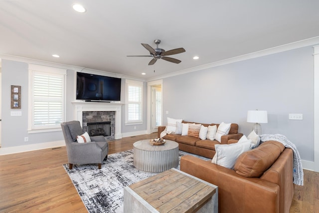 212 Rich Cir, Franklin, TN 37064 - living room featuring crown molding, a ceiling fan, a fireplace, light wood-type flooring, and recessed lighting