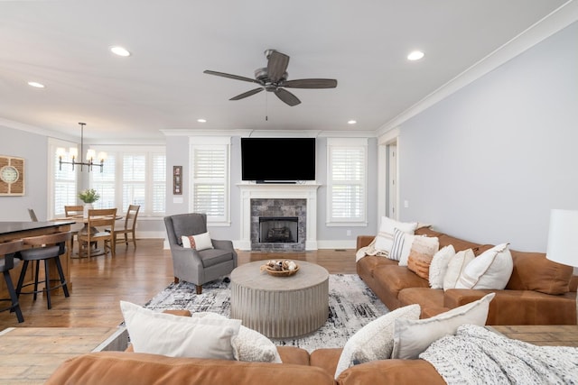 212 Rich Cir, Franklin, TN 37064 - living room featuring crown molding, a chandelier, ceiling fan, light wood finished floors, and healthy amount of natural light