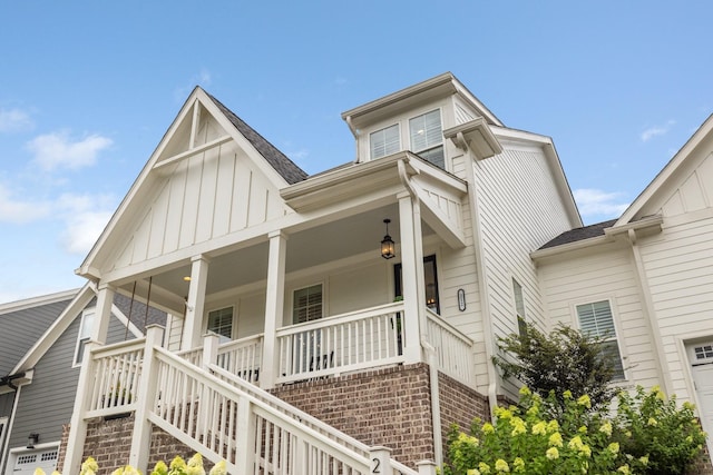212 Rich Cir, Franklin, TN 37064 - view of front of home with covered porch, board and batten siding, stairs, a shingled roof, and a garage