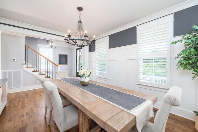 212 Rich Cir, Franklin, TN 37064 - dining space with a chandelier, stairs, wood finished floors, a decorative wall, and ornamental molding