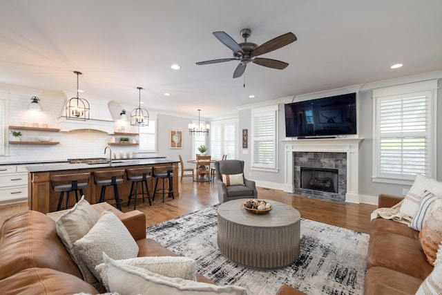 212 Rich Cir, Franklin, TN 37064 - living area with healthy amount of natural light, a ceiling fan, light wood-style floors, recessed lighting, and crown molding