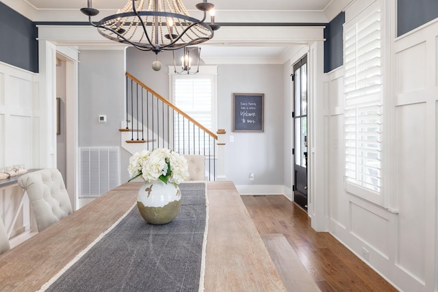 212 Rich Cir, Franklin, TN 37064 - dining space with a chandelier, wood finished floors, ornamental molding, stairway, and healthy amount of natural light
