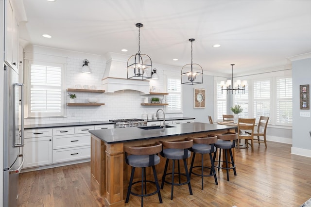 212 Rich Cir, Franklin, TN 37064 - kitchen featuring dark countertops, open shelves, high quality fridge, a chandelier, and a kitchen bar