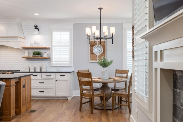 212 Rich Cir, Franklin, TN 37064 - dining area featuring a chandelier, plenty of natural light, light wood-type flooring, and ornamental molding