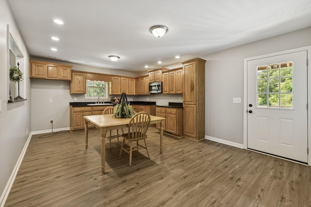 92 Defeated Creek Hwy, Carthage, TN 37030 - kitchen with recessed lighting, wood finished floors, dark countertops, stainless steel microwave, and brown cabinetry