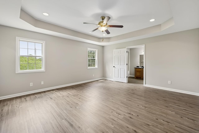 92 Defeated Creek Hwy, Carthage, TN 37030 - unfurnished bedroom featuring a tray ceiling, wood finished floors, recessed lighting, ensuite bath, and ceiling fan