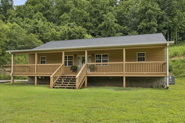 92 Defeated Creek Hwy, Carthage, TN 37030 - view of front of property featuring a front yard, a porch, roof with shingles, stairs, and a wooded view