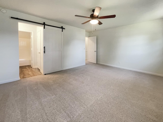 1002 E Northfield Blvd Unit H104, Murfreesboro, TN 37130 - unfurnished bedroom with carpet flooring, a barn door, a ceiling fan, and ensuite bath