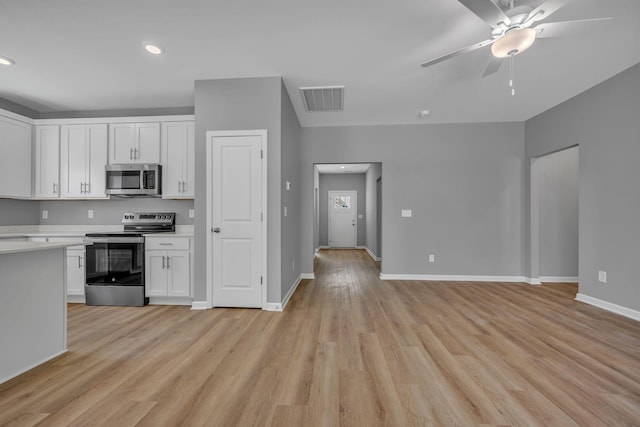 209 E Quail Hollow Way, Dickson, TN 37055 - kitchen with appliances with stainless steel finishes, light countertops, light wood finished floors, white cabinets, and recessed lighting