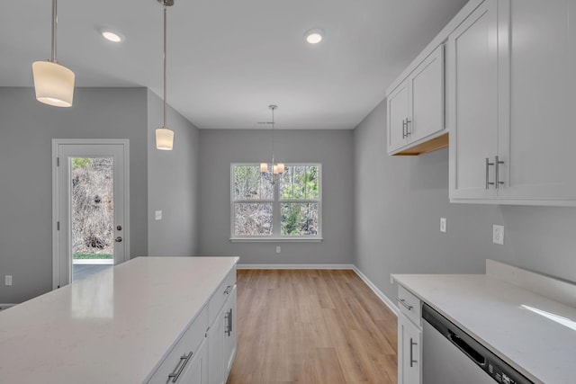 209 E Quail Hollow Way, Dickson, TN 37055 - kitchen with light wood finished floors, dishwasher, white cabinetry, a chandelier, and hanging light fixtures