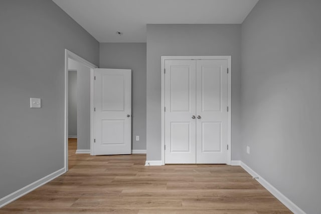 209 E Quail Hollow Way, Dickson, TN 37055 - unfurnished bedroom featuring a closet and light wood-type flooring