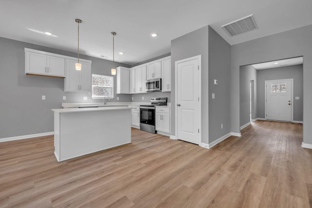 209 E Quail Hollow Way, Dickson, TN 37055 - kitchen with appliances with stainless steel finishes, white cabinets, light wood-type flooring, light countertops, and recessed lighting