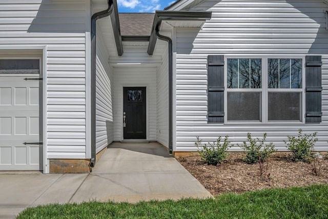 209 E Quail Hollow Way, Dickson, TN 37055 - view of exterior entry with a garage and roof with shingles