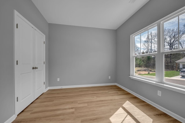 209 E Quail Hollow Way, Dickson, TN 37055 - unfurnished bedroom with multiple windows and light wood-style floors